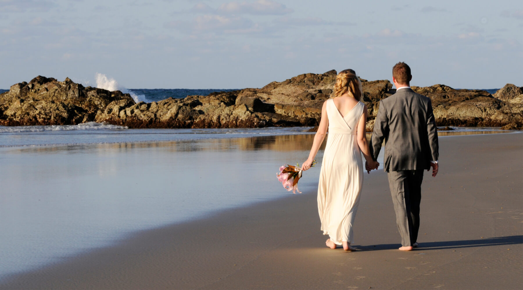 Wedding couple walking on the beach